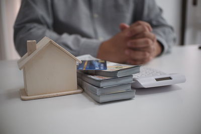 Midsection of businessman using mobile phone on table