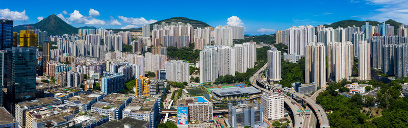 Panoramic view of modern buildings in city against sky