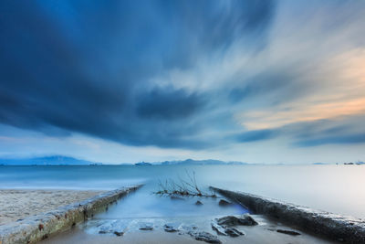 Scenic view of lake against sky during winter