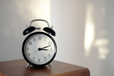 Close-up of clock on table at home