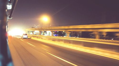 Blurred motion of car on road at night