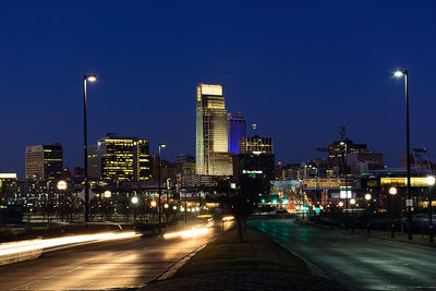 Illuminated city street at night