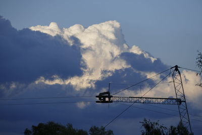 Low angle view of electricity pylon against sky