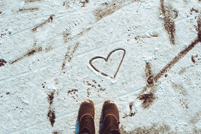 Top view of black shoes boots footprint in fresh snow. winter season, valentines day