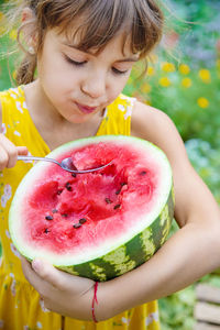 Close-up of cute girl holding fruit