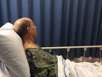 Side view of patient lying on hospital bed 