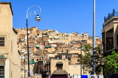 Low angle view of buildings against clear blue sky