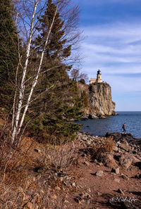 Rock formations by sea against sky