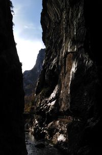 Rock formations by sea against sky