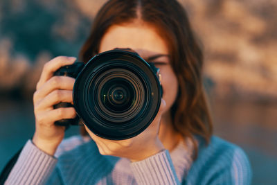 Portrait of woman photographing