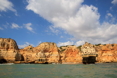 Panoramic view of rocks and sea against sky