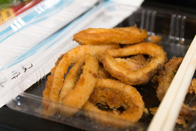 Close-up of fried squid rings in container