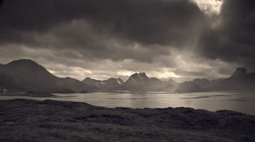 Scenic view of sea and mountains against sky