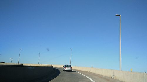 Cars on road against clear sky