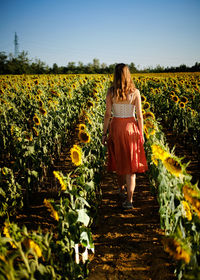 Young woman standing amidst plants