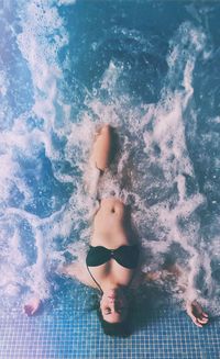 High angle view of woman swimming in pool