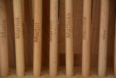 Close-up of pens in wooden rack