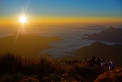 People at phu chi fa against sky during sunrise