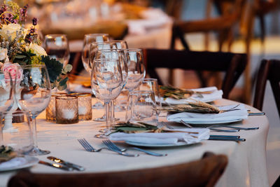 Luxury table settings for fine dining with and glassware, pouring wine to glass. 