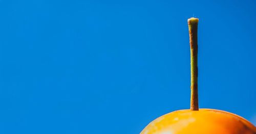 Low angle view of yellow structure against clear blue sky