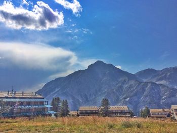 Scenic view of field and mountains against sky