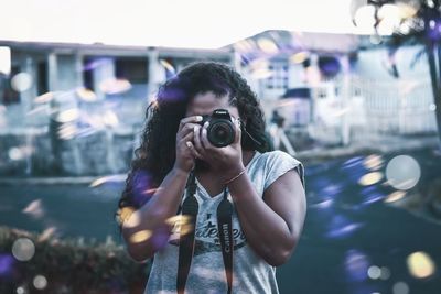 Woman photographing at camera