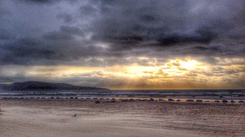Scenic view of sea against cloudy sky