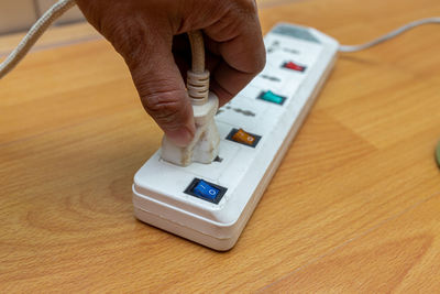 High angle view of person using mobile phone on table