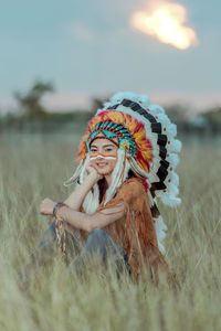 Portrait of woman wearing hat on field