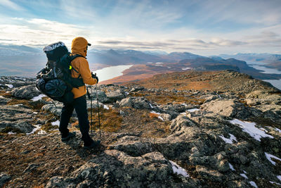 Rear view of man standing on mountain