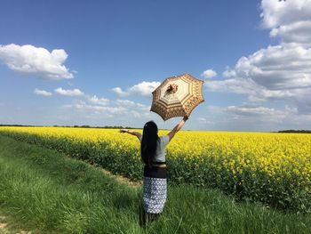 Rear view of woman standing on field