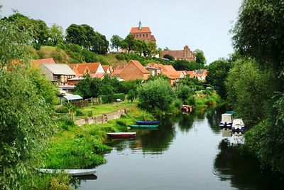 Boats in river with buildings in background