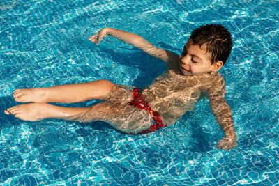 High angle view of boy swimming in pool