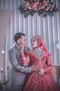 Friends standing against wall