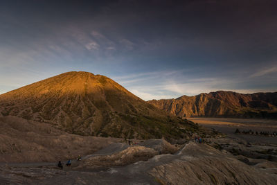 Scenic view of desert against sky during sunset