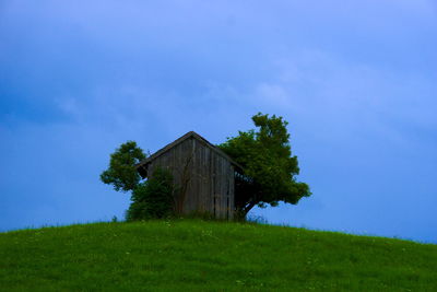 Abandoned building on field against sky