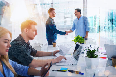Business colleagues working in office