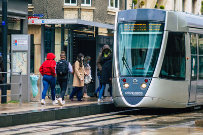 People walking on road in city