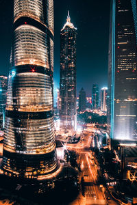 Aerial view of city lit up at night