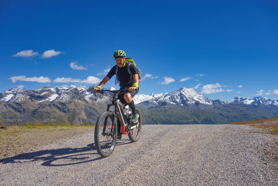 Man riding bicycle on road