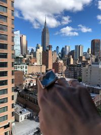 Man holding modern buildings in city