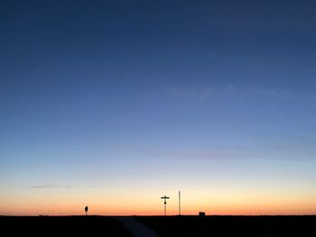 Silhouette landscape against clear sky during sunset