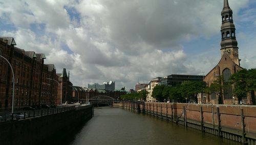 Empty road with buildings in background