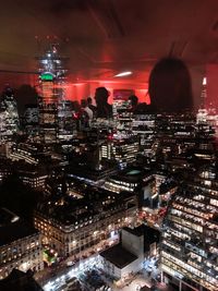 Aerial view of illuminated city buildings at night