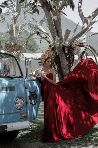Woman with umbrella standing in car