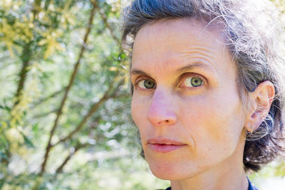 Close-up portrait of woman with green eyes