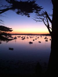 Scenic view of lake against sky at sunset