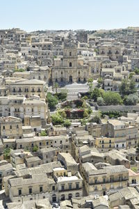 Buildings in city against clear sky