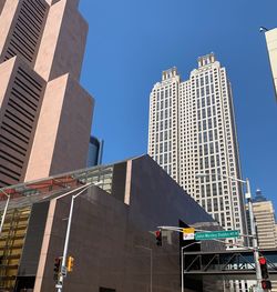 Low angle view of modern buildings against sky in city