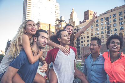 Happy friends on building terrace